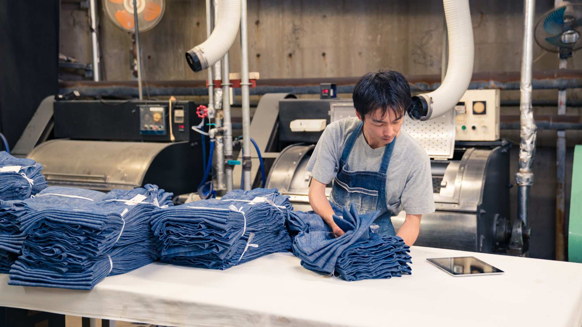 A man performing quality control on jeans